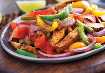 mexican chicken fajitas in iron skillet with peppers