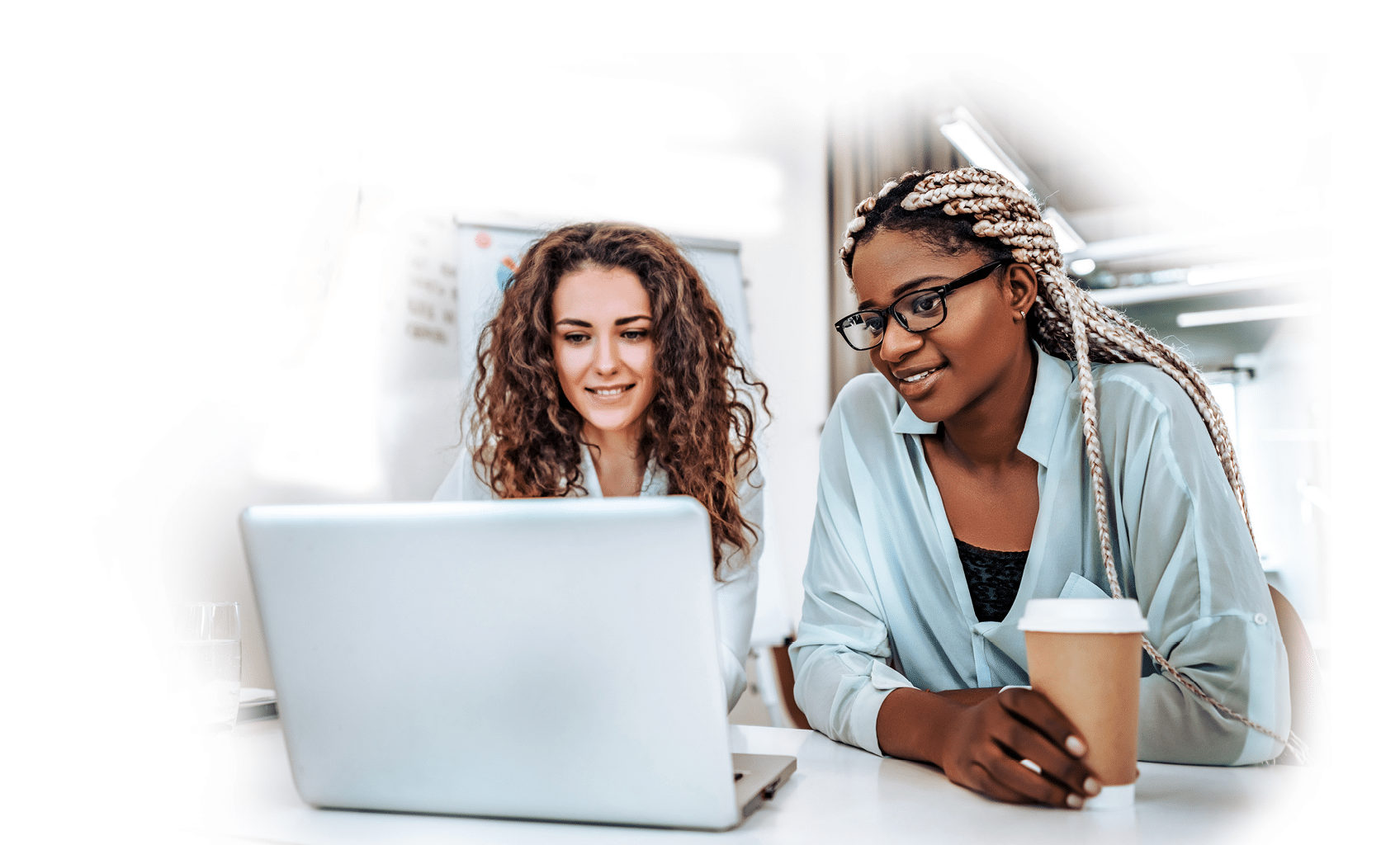 Joyful young business women looking at laptop screen while rest from work 