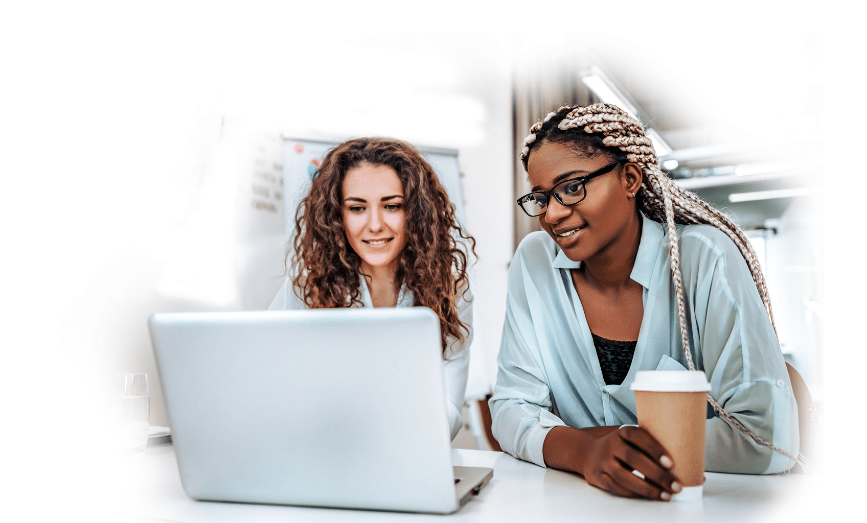 Joyful young business women looking at laptop screen while rest from work 